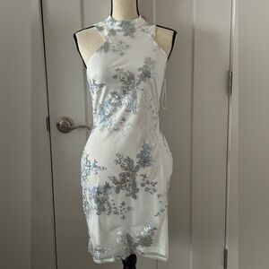 Gorgeous white sleeveless dress. Back zip with silver sequins detail. Size S